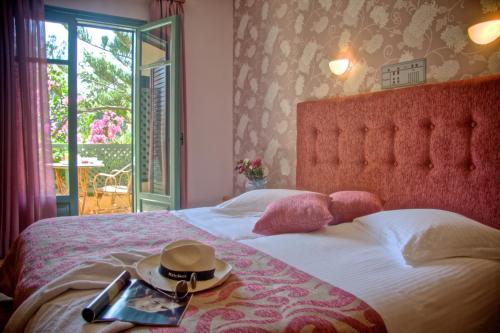a bedroom with a bed with a hat on it at Solimar Ruby in Malia