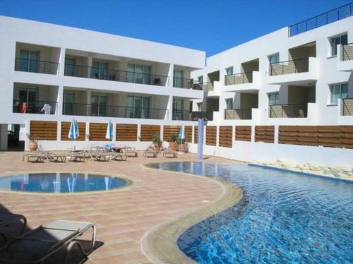 a hotel with a swimming pool in front of a building at Chromata Lagoon in Protaras