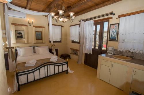 a bedroom with a bed and a sink and a mirror at kritikies1 in Pitsidia