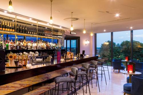 a bar at a restaurant with bar stools at ABode Chester in Chester
