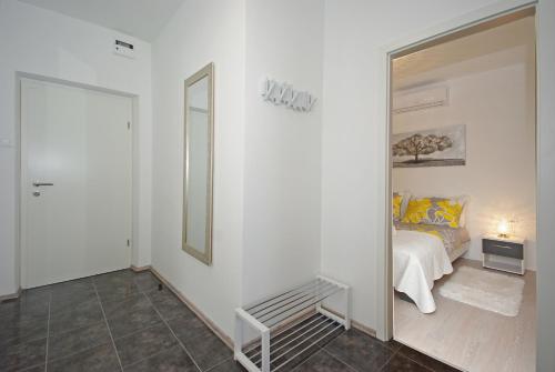 a white bedroom with a bed and a mirror at "NM" Luxury apartments in Split