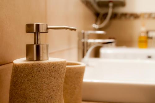 a bathroom with a soap dispenser on a sink at CA' DE' KOCAI in Venice