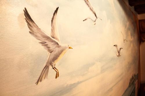 a white bird flying in the sky at CA' DE' KOCAI in Venice