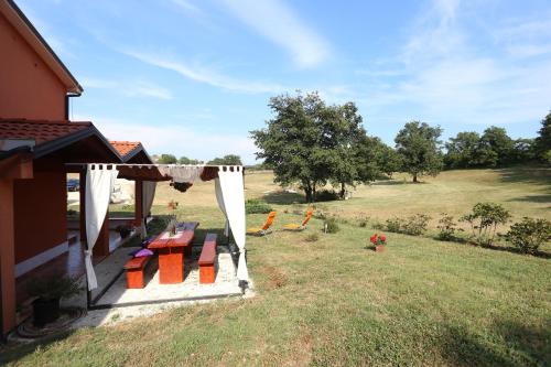 a backyard with a gazebo with colorful blocks on it at Apartments Matelici in Divšići