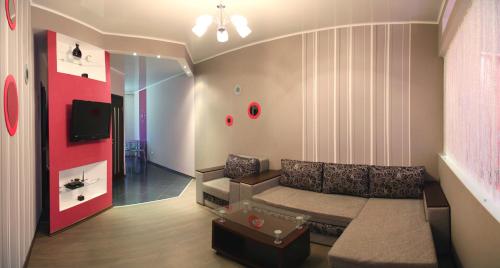 a living room with a couch and a tv at Apartment Dekabrystiv in Mykolaiv