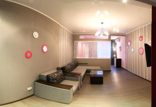 a living room with a couch and a table at Apartment Dekabrystiv in Mykolaiv