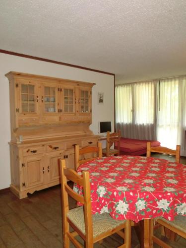 a dining room with a table and some chairs and a table and a tableministic at Bilocali Alberti - Des Alpes in Madonna di Campiglio