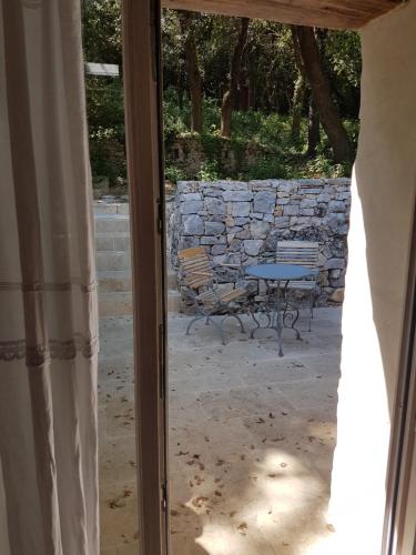 a window view of a patio with a table and chairs at Le Domaine Saint Martin in Flassans-sur-Issole