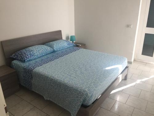 サンタ・マリア・アル・バーニョにあるCasa Santa Maria al Bagnoのベッドルーム1室(青い掛け布団付きのベッド1台付)