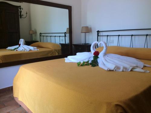 a hotel room with two beds with white towels at Agriturismo del Sole in Anacapri