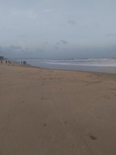 a group of people walking on the beach at Dona Rosa Holiday Apartment in Varca