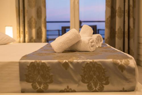 a towel sitting on top of a bed at Mare Studios Exclusive in Plomarion