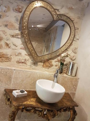 a bathroom with a white sink and a mirror at Le Domaine Saint Martin in Flassans-sur-Issole