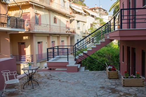 a staircase in a building with a table and chairs at Mare Studios Exclusive in Plomarion