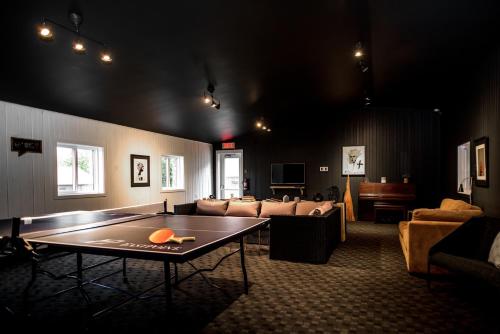 a living room with a ping pong table in it at Beatnik Hotel in Bromont