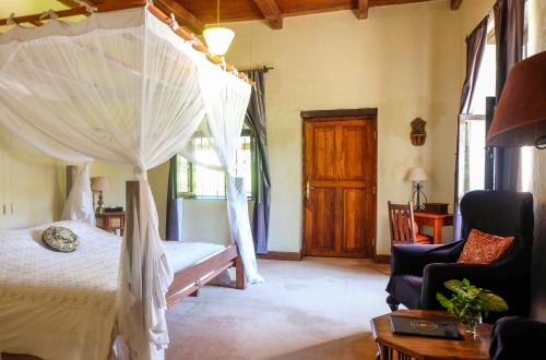 a bedroom with a bed with a canopy at Ngare Sero Mountain Lodge in Usa River