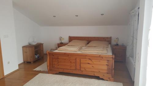 a bedroom with a wooden bed and two night stands at Casa Bellavista in Rijeka