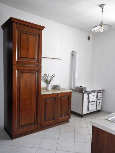 a kitchen with a large wooden cabinet in a room at Al Fiume in Arco