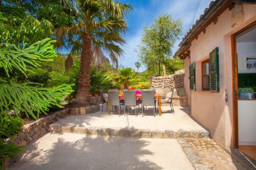 a patio with a table and chairs in front of a house at Can Sucre in Sóller