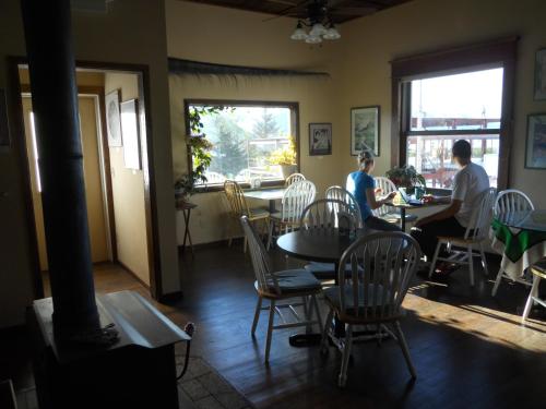 two people sitting at tables in a restaurant at A Swan Nest Inn in Seward