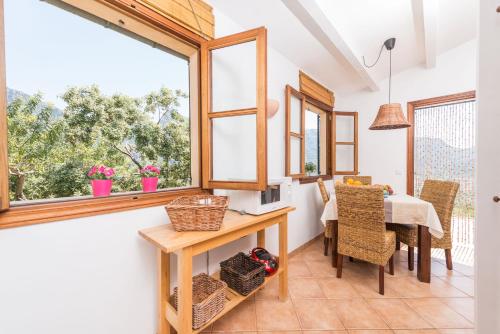 a dining room with a table and a window at Son Bou in Sóller