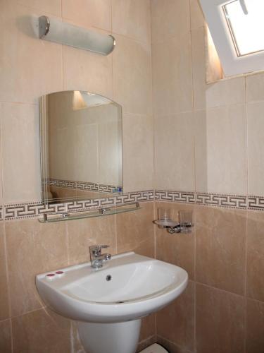 a bathroom with a sink and a mirror at Hotel Sapphire in Primorsko