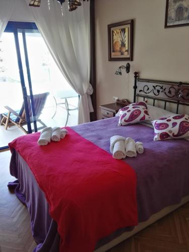 a bedroom with a bed with towels on it at Apartamento en Playa Capellans in Salou