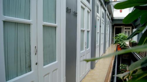 a row of white doors on a building at Hotel Principal in Mexico City