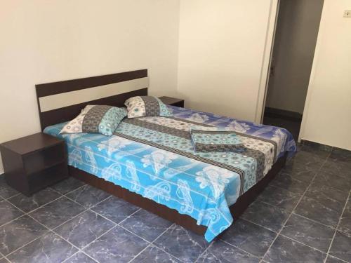 a bed with two pillows on it in a room at Bungalow Eforie Nord in Eforie Nord
