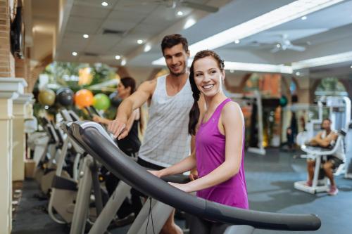 a man and a woman standing in a gym at Occidental at Xcaret Destination - All Inclusive in Playa del Carmen