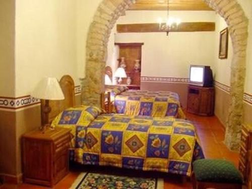 Ένα ή περισσότερα κρεβάτια σε δωμάτιο στο Hotel Reyna Soledad