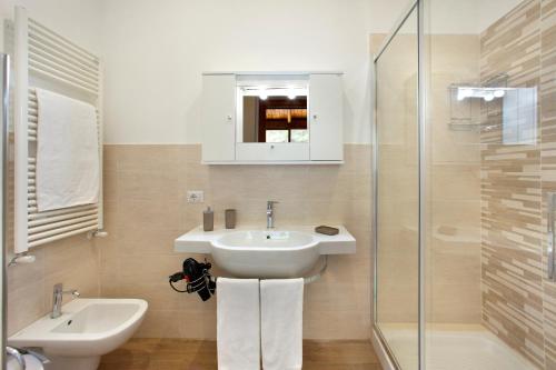 une salle de bain avec un lavabo, des toilettes et une douche dans l'établissement Appartamento degli Ulivi 2, à Sant'Agnello