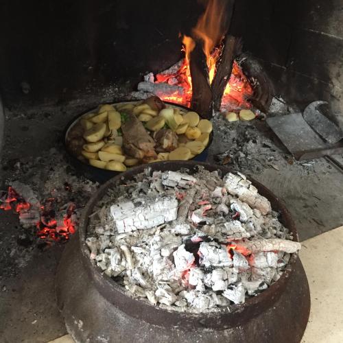a grill with a bunch of food and a fire at Apartment sea view, Terrace, Parking near Korcula in Korčula