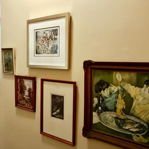 a group of framed pictures hanging on a wall at Vine Valley Inn in Cessnock