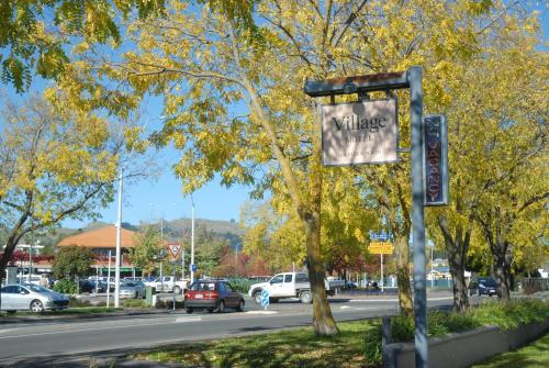 a sign for a village on the side of a street at Village Motel in Havelock North