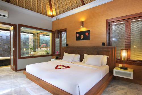 Lova arba lovos apgyvendinimo įstaigoje Abi Bali Resort and Villa