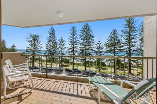 a balcony with chairs and a view of the ocean at Columbia Beachfront Apartments on Rainbow Bay in Gold Coast
