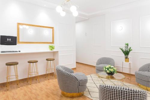 een wachtkamer met stoelen en een witte muur bij Hostal Oriente in Madrid