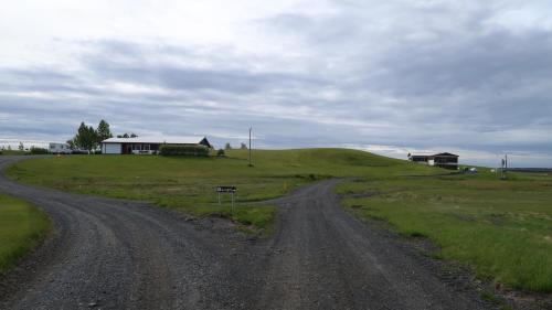 a dirt road in the middle of a field at Hvoll Hostel in Kirkjubæjarklaustur
