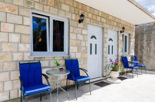 a group of chairs and a table on a patio at Apartments Versus in Mlini