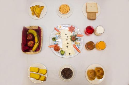 a white table with plates of food on it at S Chalet Islamabad in Islamabad