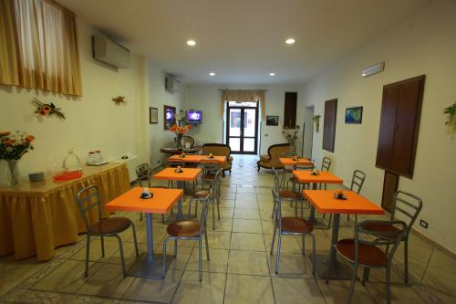 a room with tables and chairs in a room at Hotel Savoia in Sapri