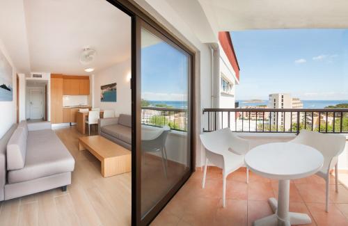 a living room with a balcony with a table and chairs at Apartamentos Sol y Vera in Magaluf