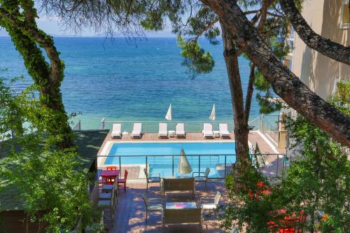 a swimming pool with a view of the ocean at Melis Hotel Kusadasi in Kusadası
