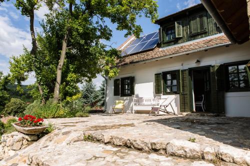 a house with solar panels on the roof at Henye holiday homes in Balatonhenye