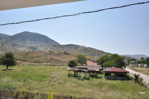 a group of houses in a field next to a road at Elite Apart Pansiyon in Gokceada Town