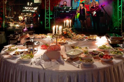 a table with plates of food on it with candles at Hotel Victoria in Szczecin