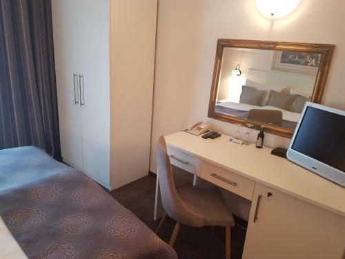 a hotel room with a desk and a computer at Hotel Argentum in Vrbnik