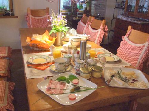 a wooden table with plates of food on it at Biohof Hausberg in Egglham