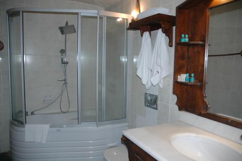 a bathroom with a shower and a toilet and a sink at Elkep Evi Cave Hotel in Urgup